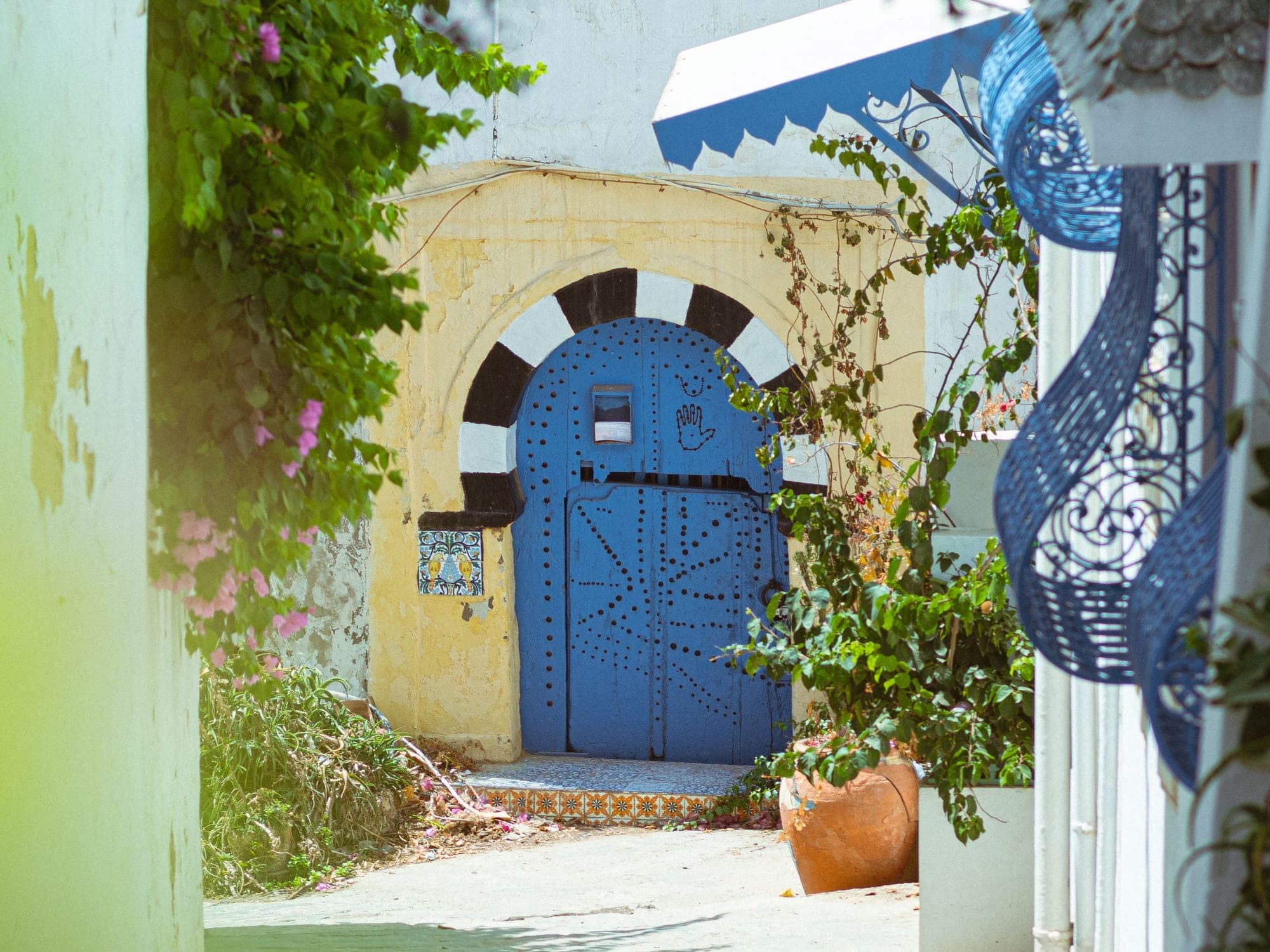 Bougainvillea over a blue door in Sidi Bou Saïd